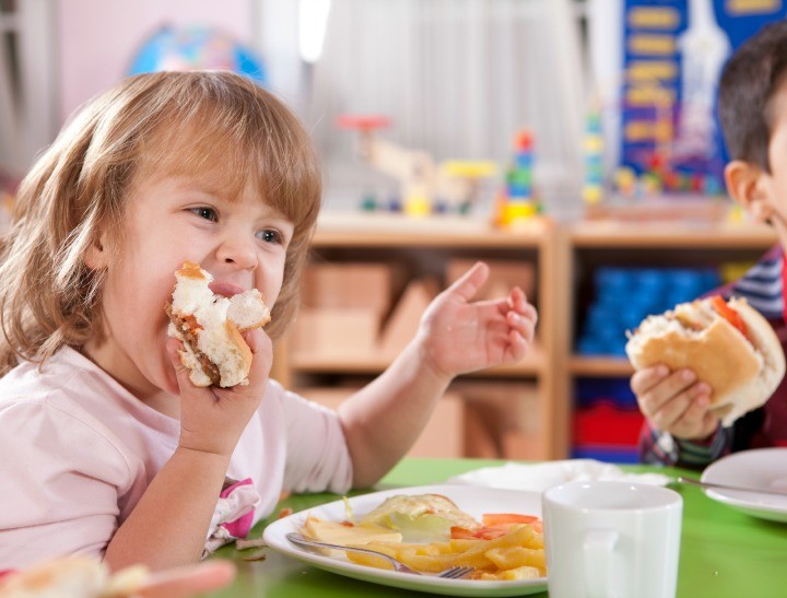 young-girl-eats-sandwich-with-gusto-720x547